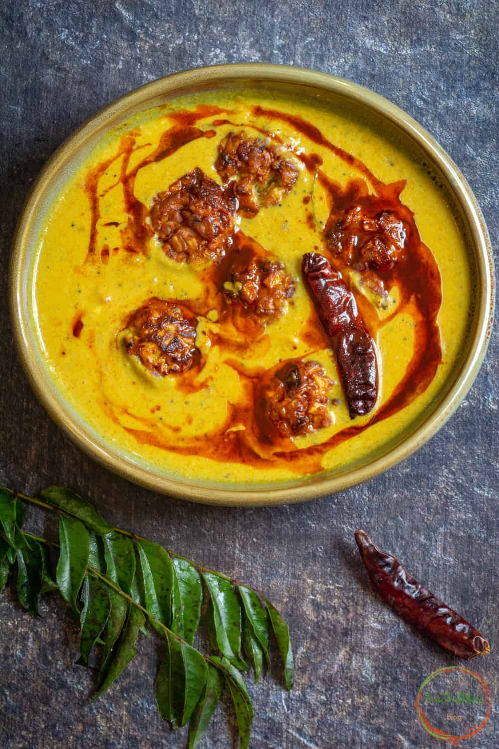 Tempering is added to kadhi pakora.