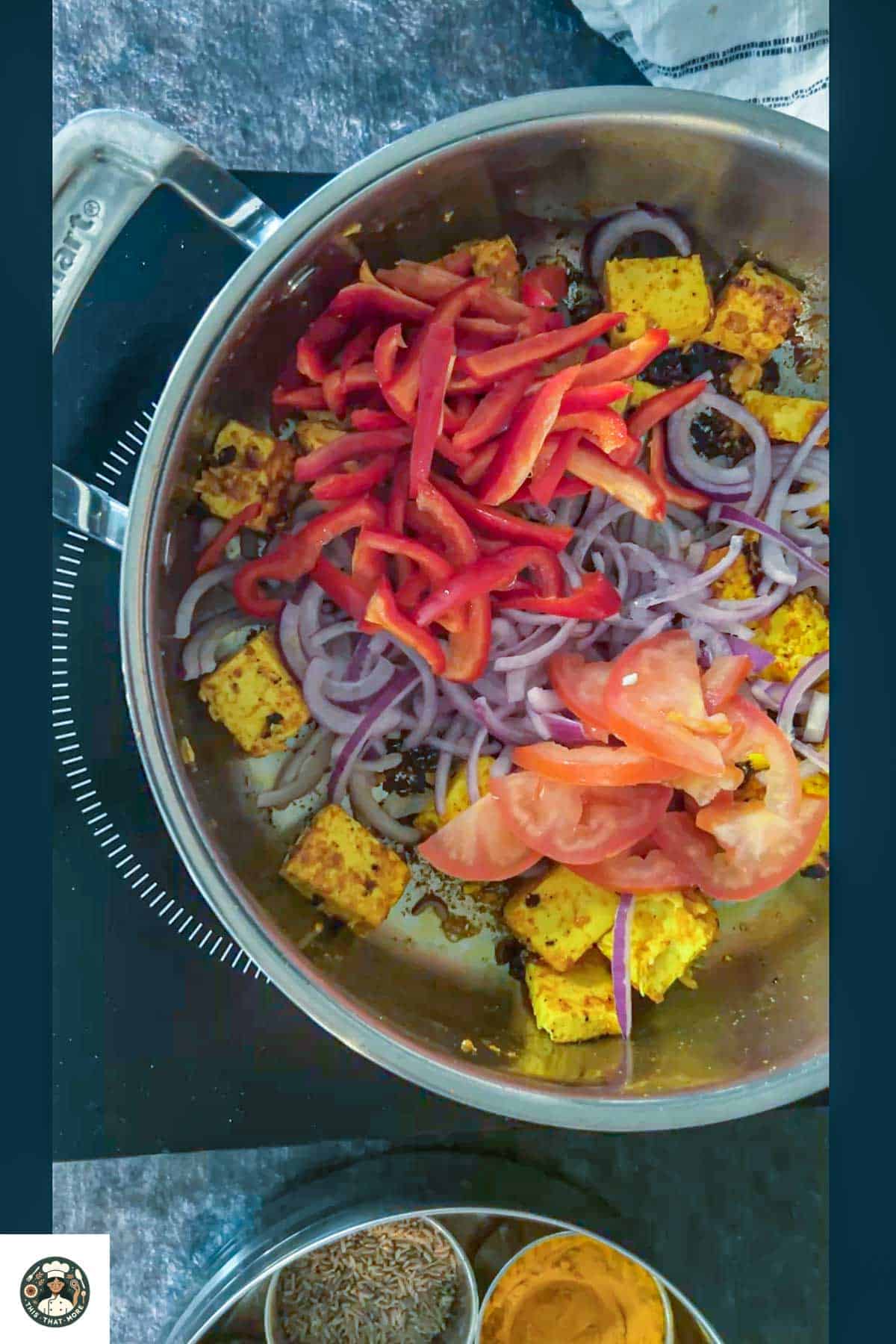 Add sliced onion, bell pepper, tomatoes, and chaat masala until onion are caramelized but veggies are still crunchy.