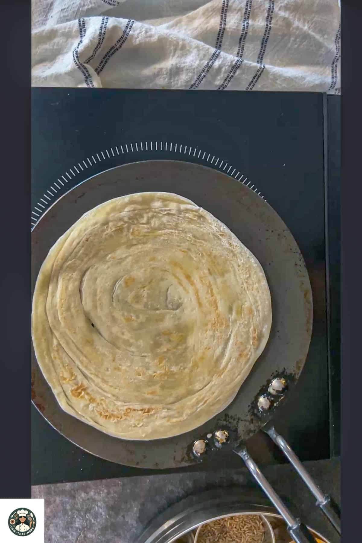 Place parantha on the pan.