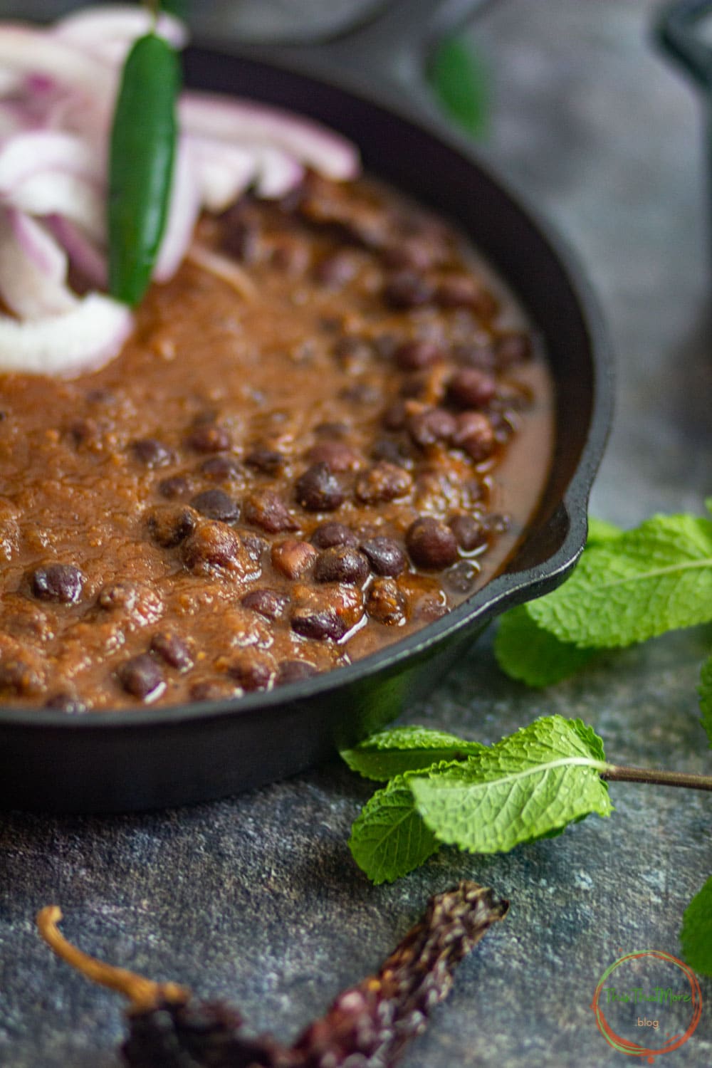 Kala Chana Curry served in a black skillet.