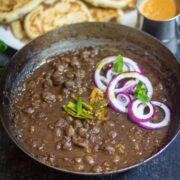 Delhi style chole served with kulcha and onion salad.