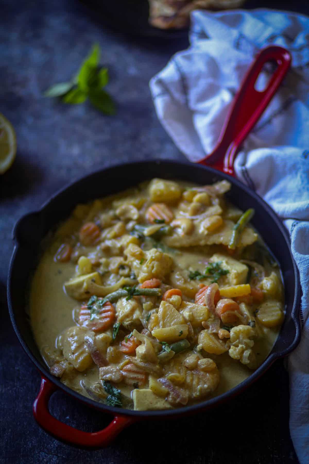 Navratan Korma in a red wok.