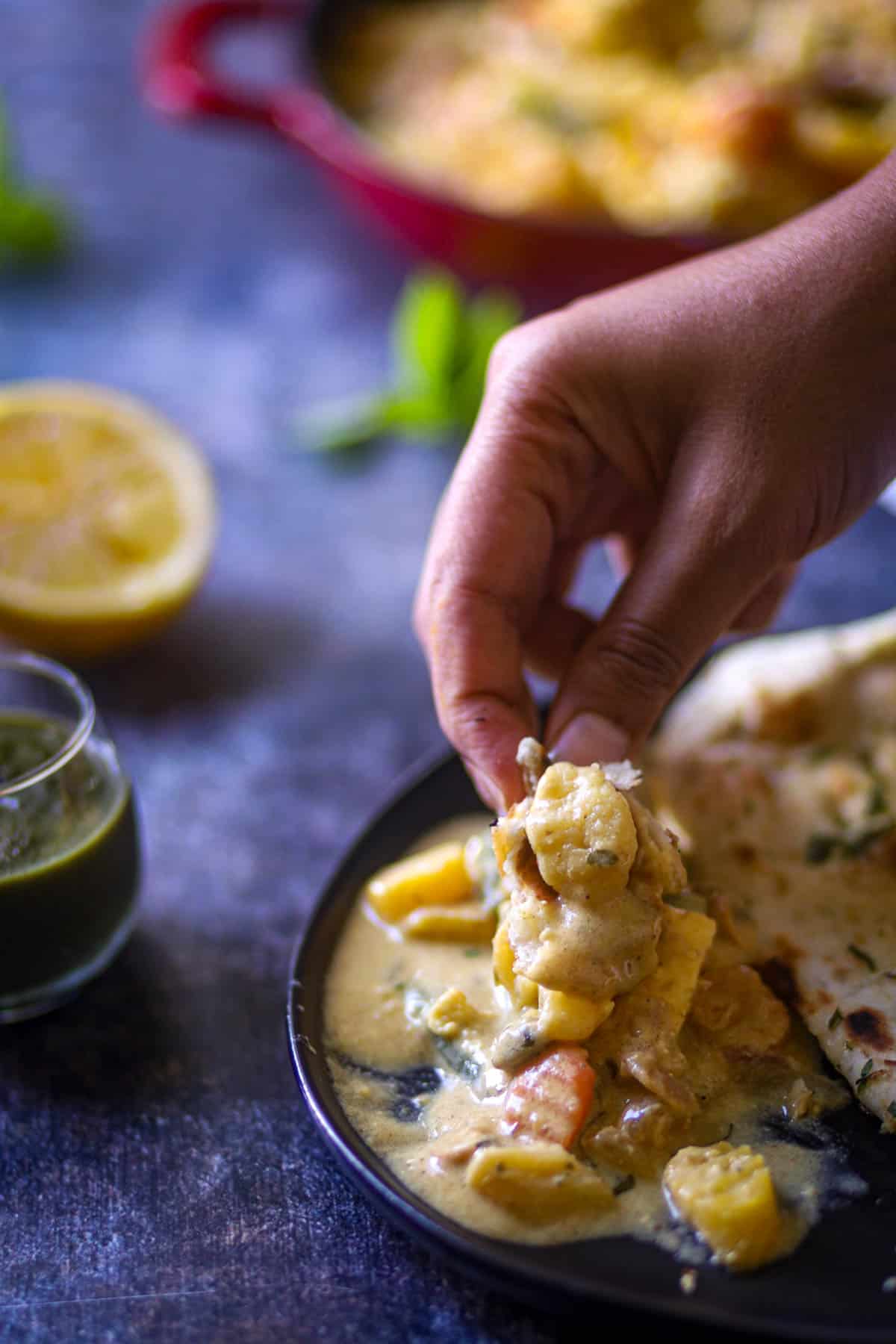 Taking a bite of navratan curry.