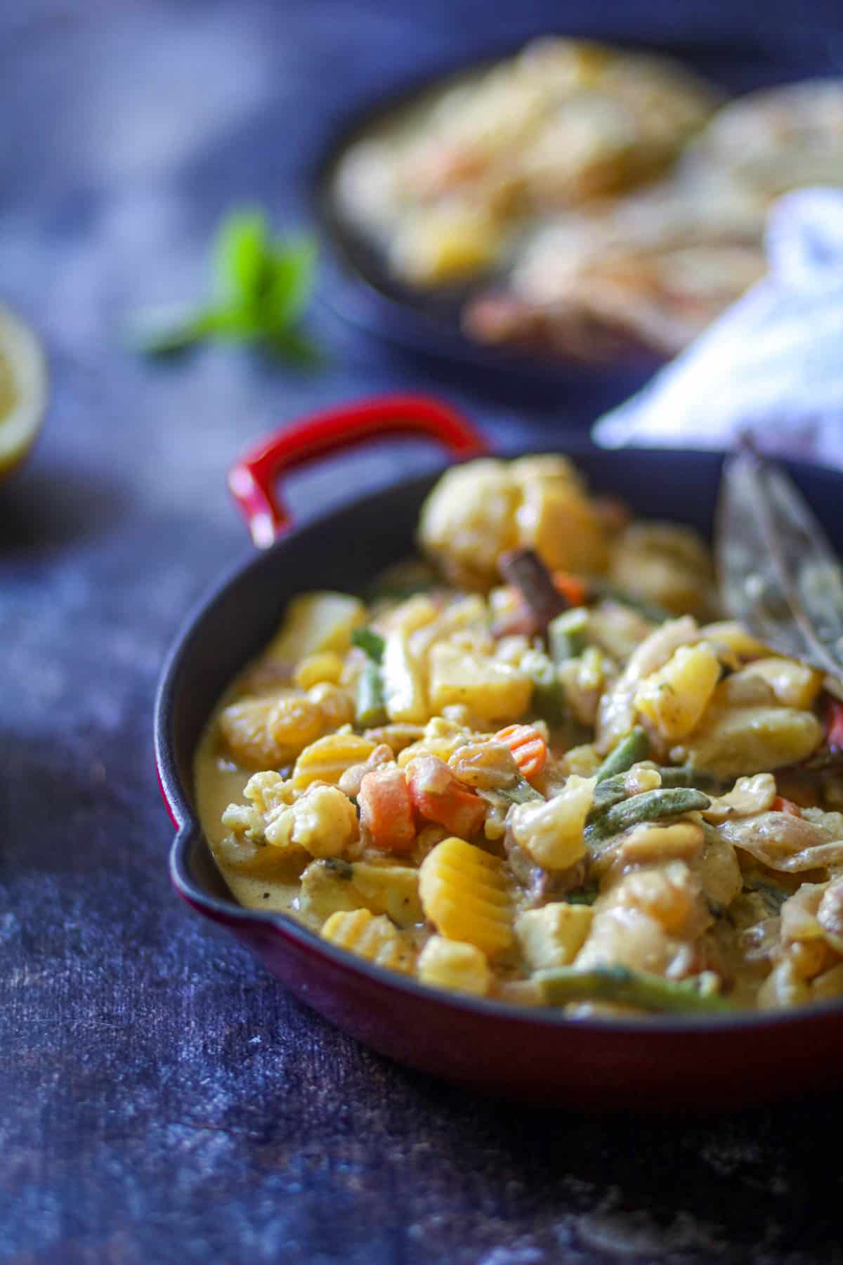 Navratan Curry garnished with cilantro and lemon juice.