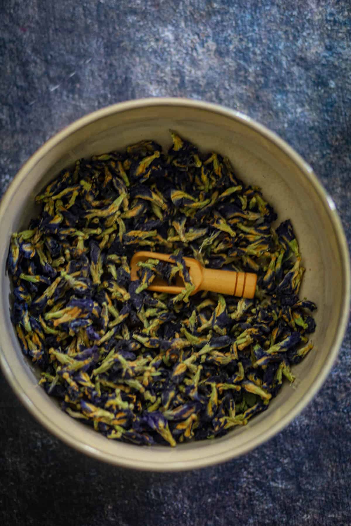 A bowl full of dried butterfly pea flowers.