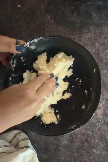 Mashed boiled potato being prepared for aloo tikki.