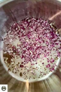 Image showing chopped onions in a big pot for sauteeing.