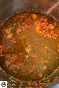 Image showing vegetable stock and spices added to the soup.