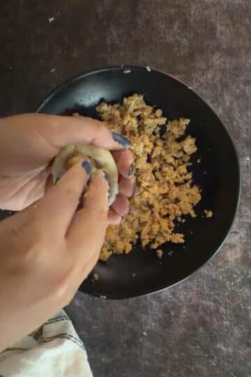 Stuffed aloo tikki shaped into a round patty