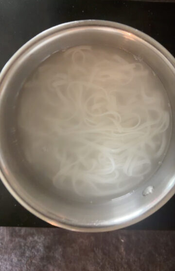 Cooking rice noodles in boiling water as per packet instrucions.
