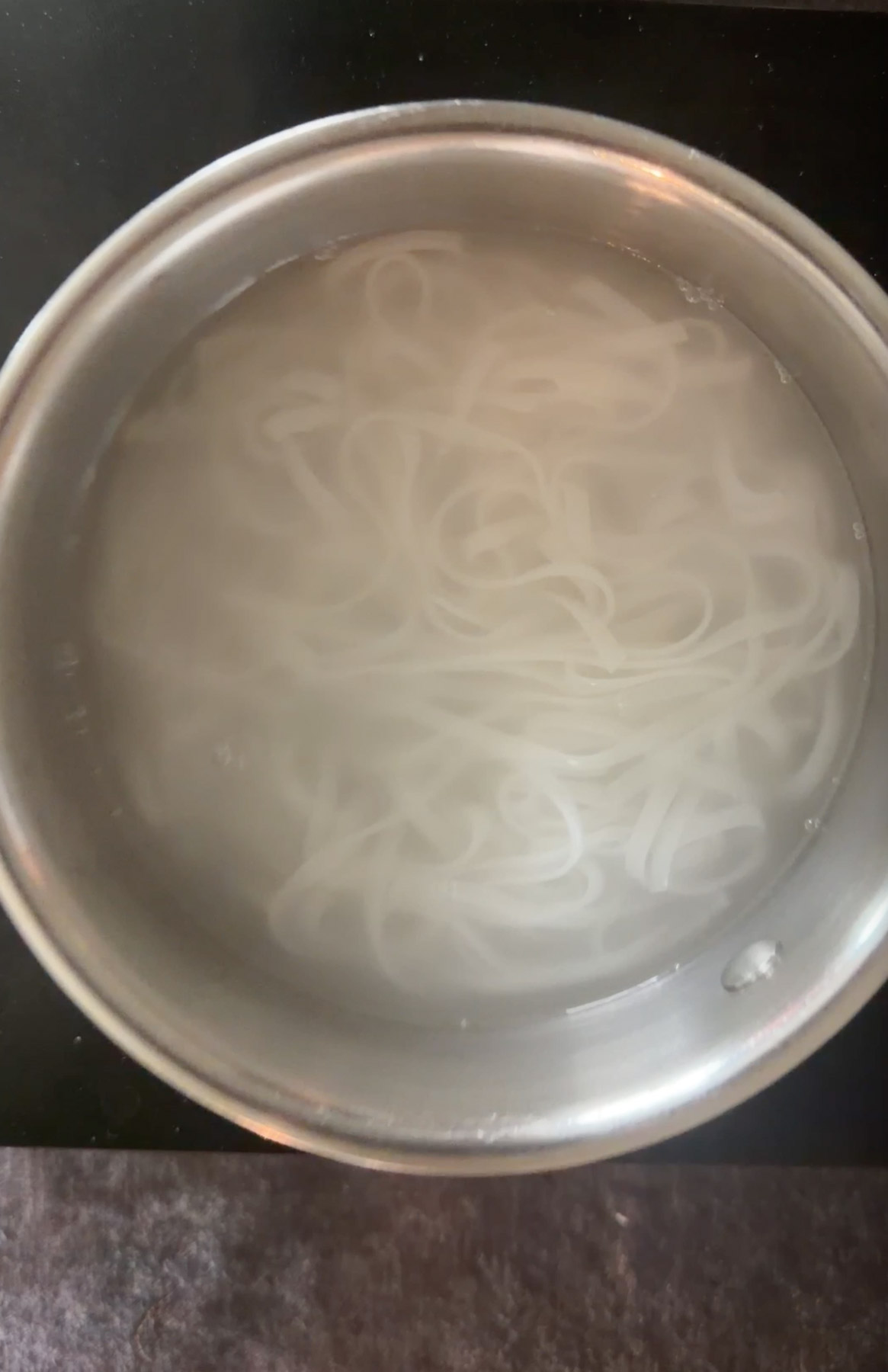 Cooking rice noodles in boiling water as per packet instrucions.