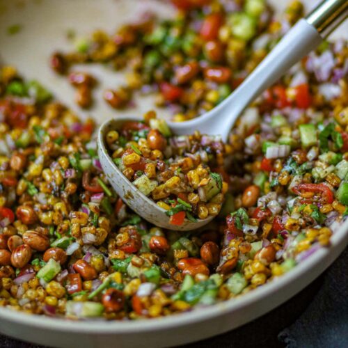 Charred corn chaat with vegetables and roasted peanuts.