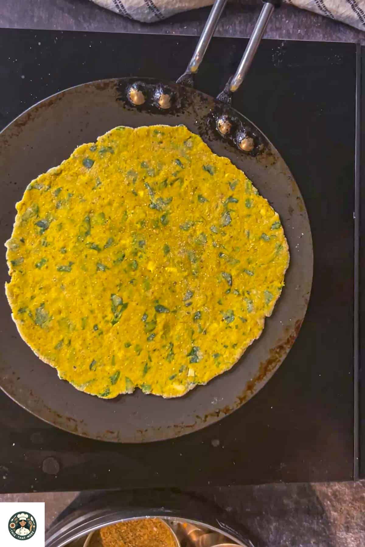 Image of paratha on a hot tawa.