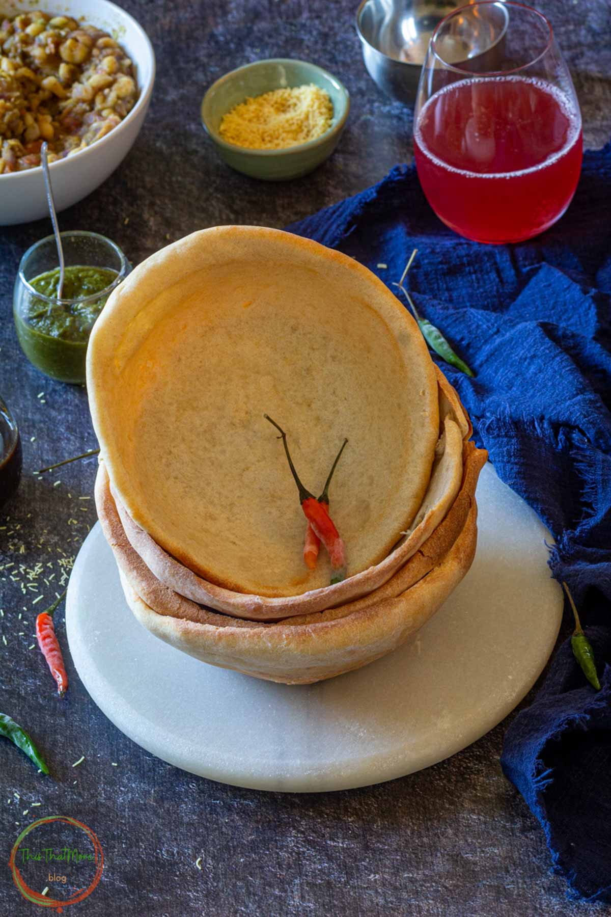 Stack of homemade naan bowls ready for filling.