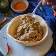 Spoon scooping chickpea filling from naan bowl.