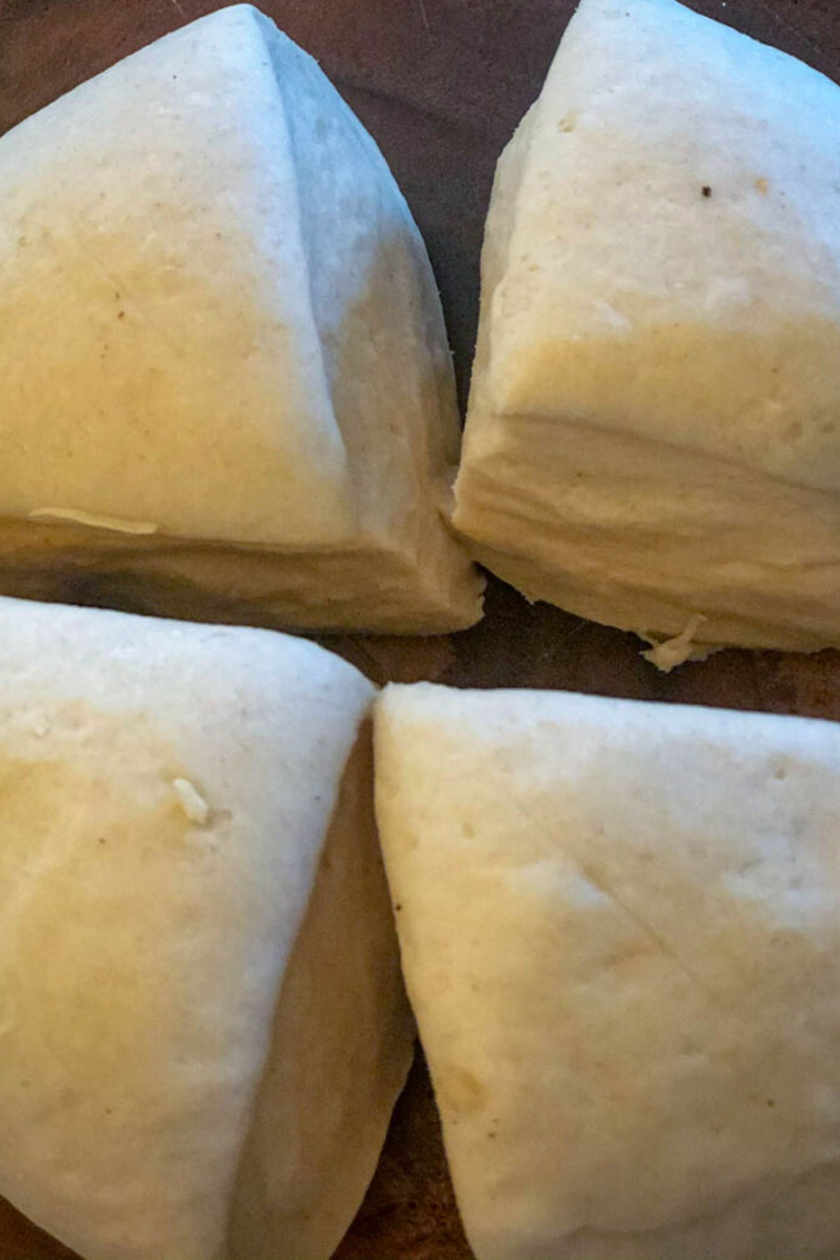 Naan dough divided into portions for shaping.