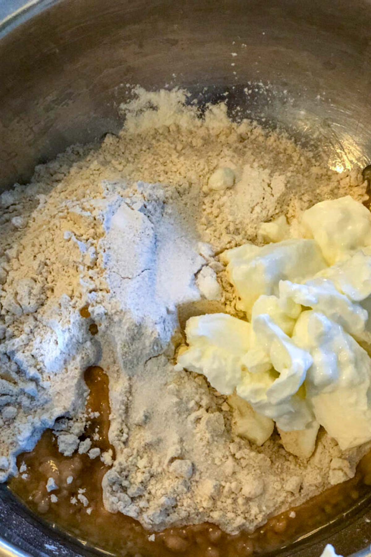 Preparing the dough by combining wet and dry ingredients.