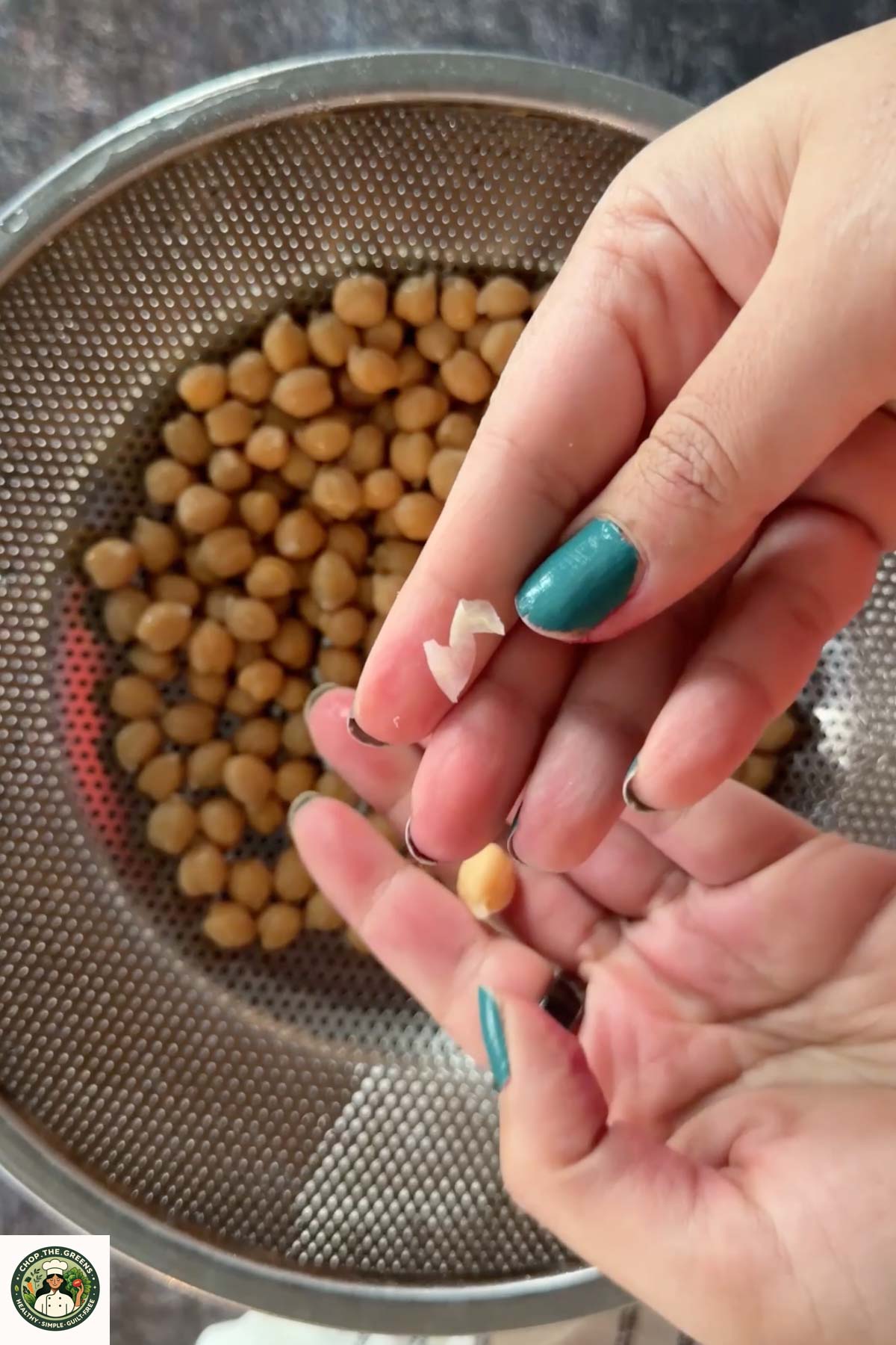 Removing chickpea skins by hand for extra smooth hummus.