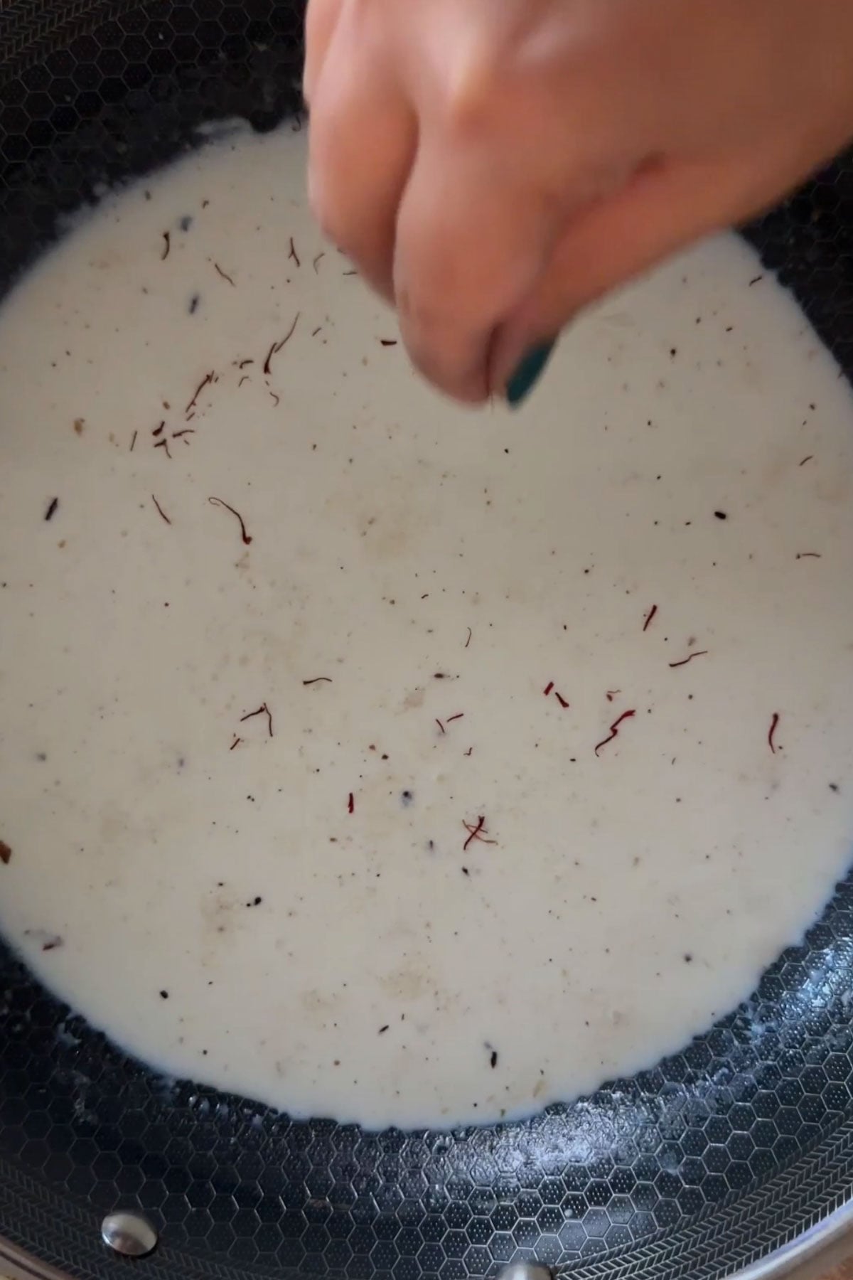 Saffron added to milk for sabudana kheer.