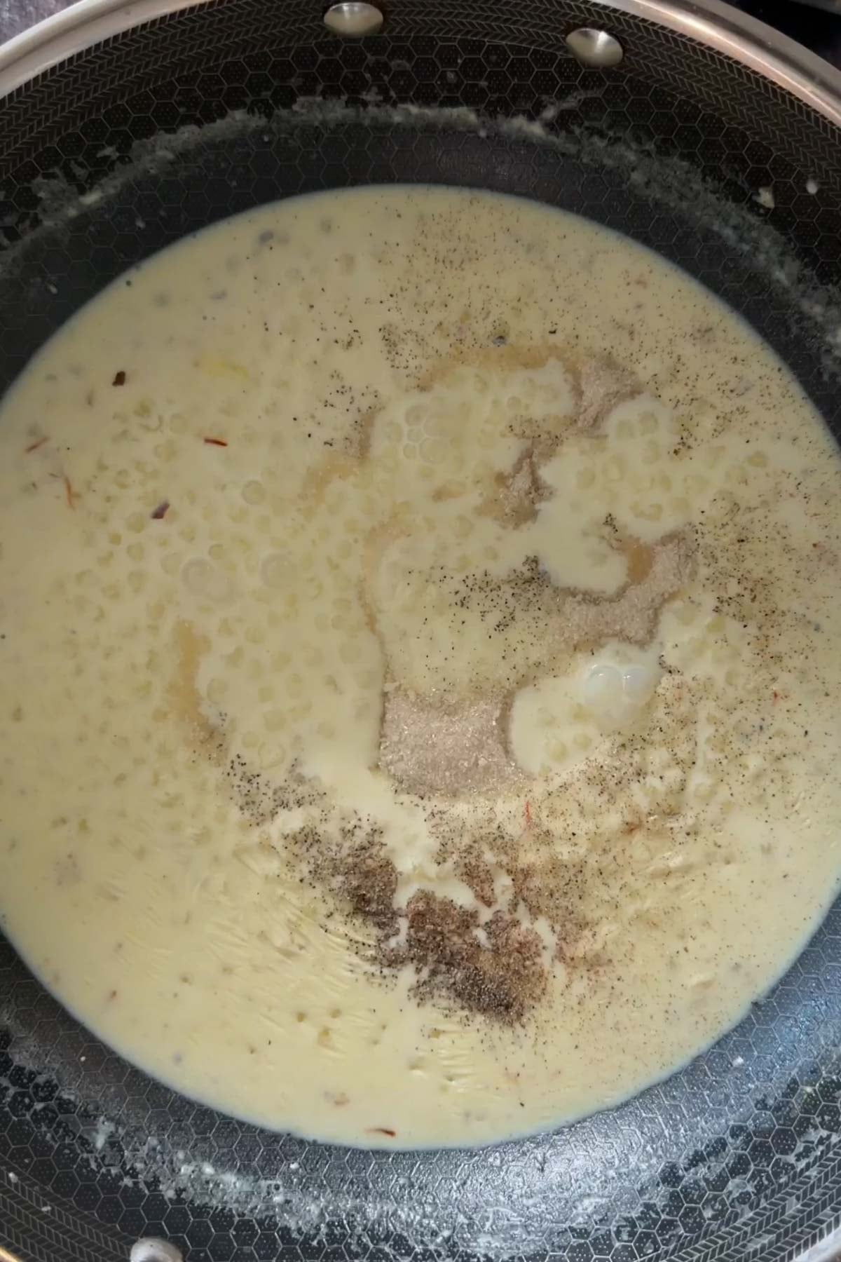 Sugar and cardamom added to sabudana kheer.