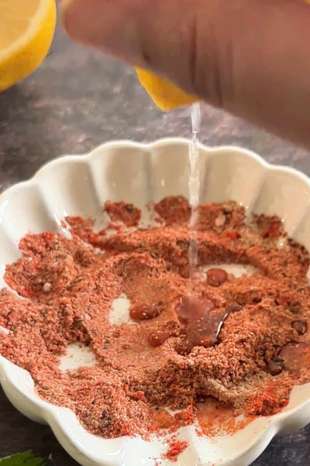 Adding lemon juice to bhutta masala spice mix.