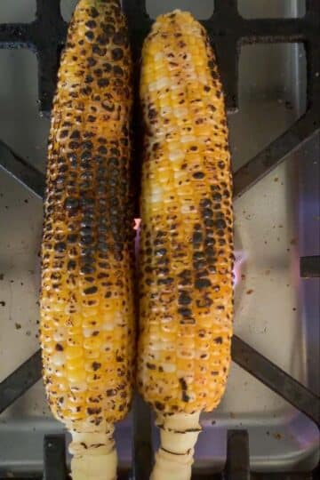 Indian corn roasting over a gas flame.