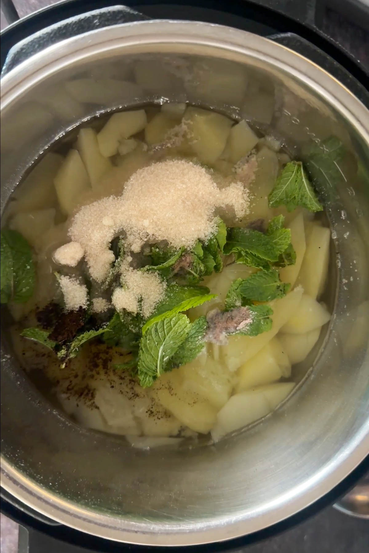 Cooked raw mango with mint, sugar, black salt and cumin for aam panna.