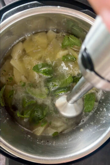 Blending cooked raw mango mixture for aam panna.