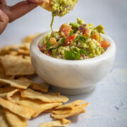 Taking a bite of guacamole in cracers.