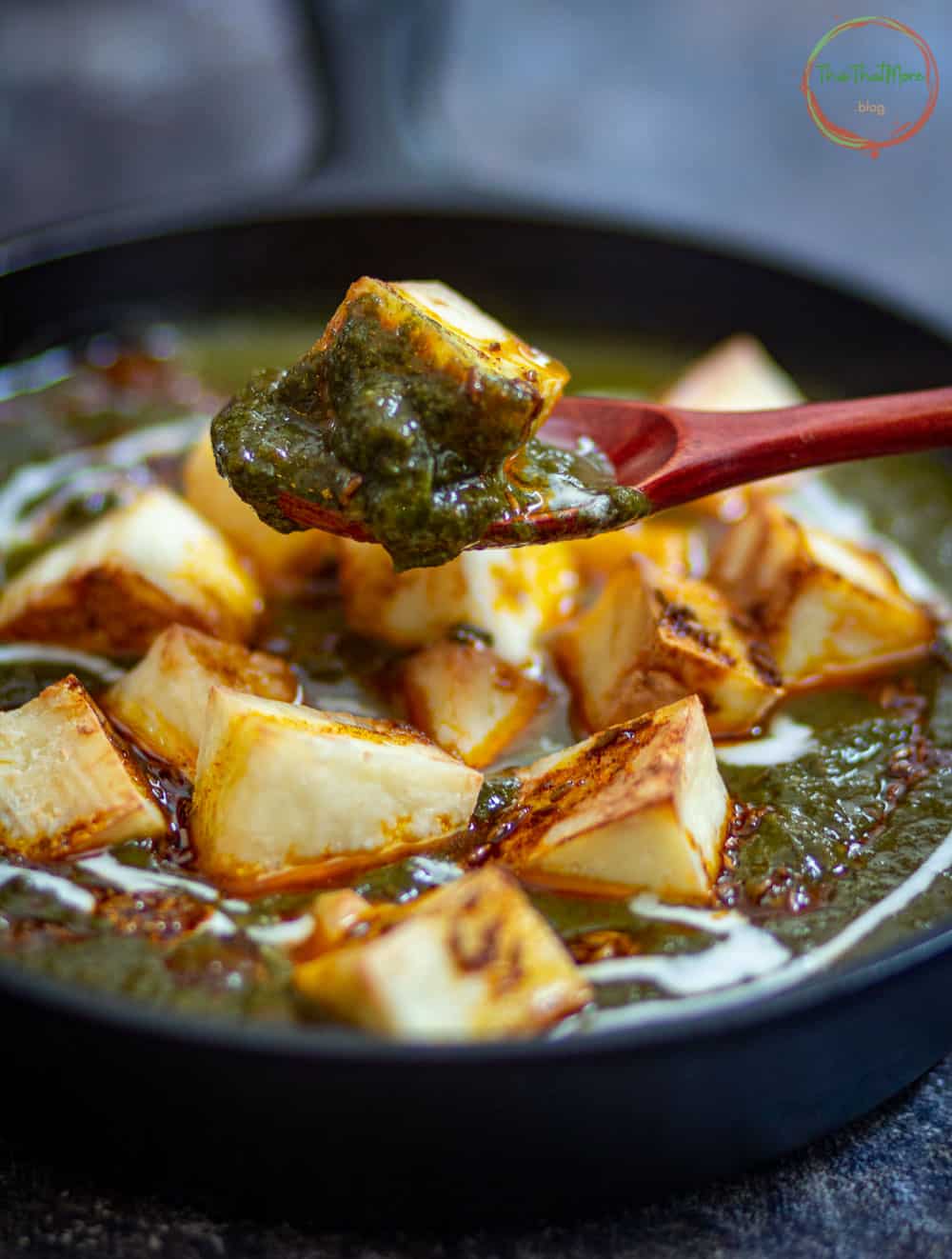 A spoon full of instant pot Palak Paneer.