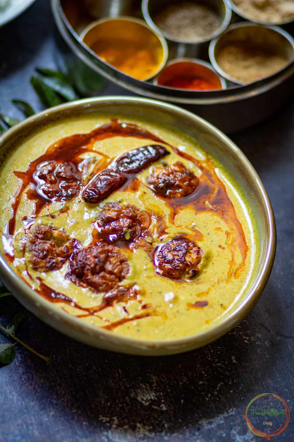 Fried red chili is served with Punjabi kadhi.
