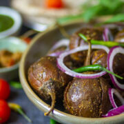 Bharwa Baingan served in a green bowl.