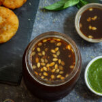 Imli Ki Meethi Chutney garnished with some melon seeds.
