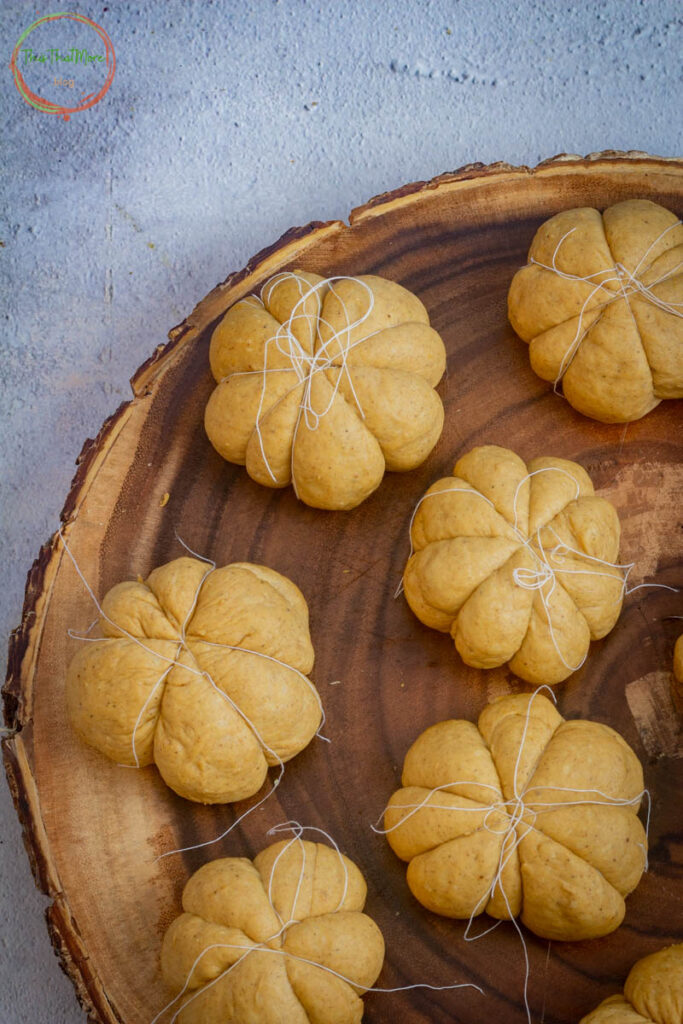 using kitchen thread, shape the balls into a pumpkin