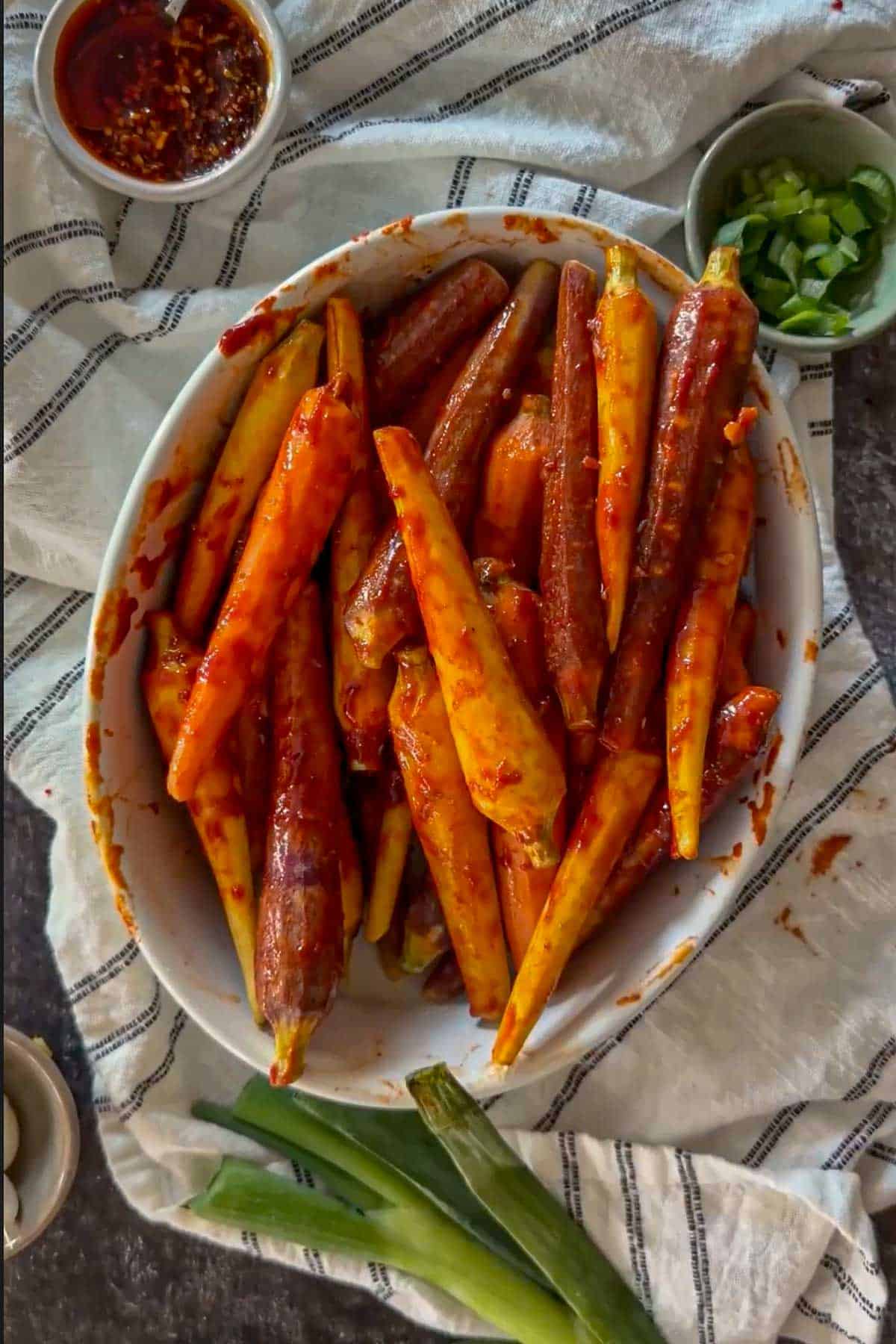 Carrots fully coated in gochujang glaze before air frying.