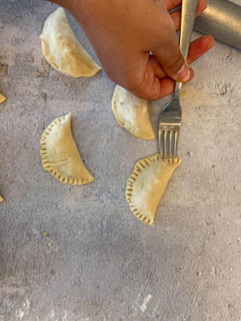 Shaping the gujiya without mold by using a fork.