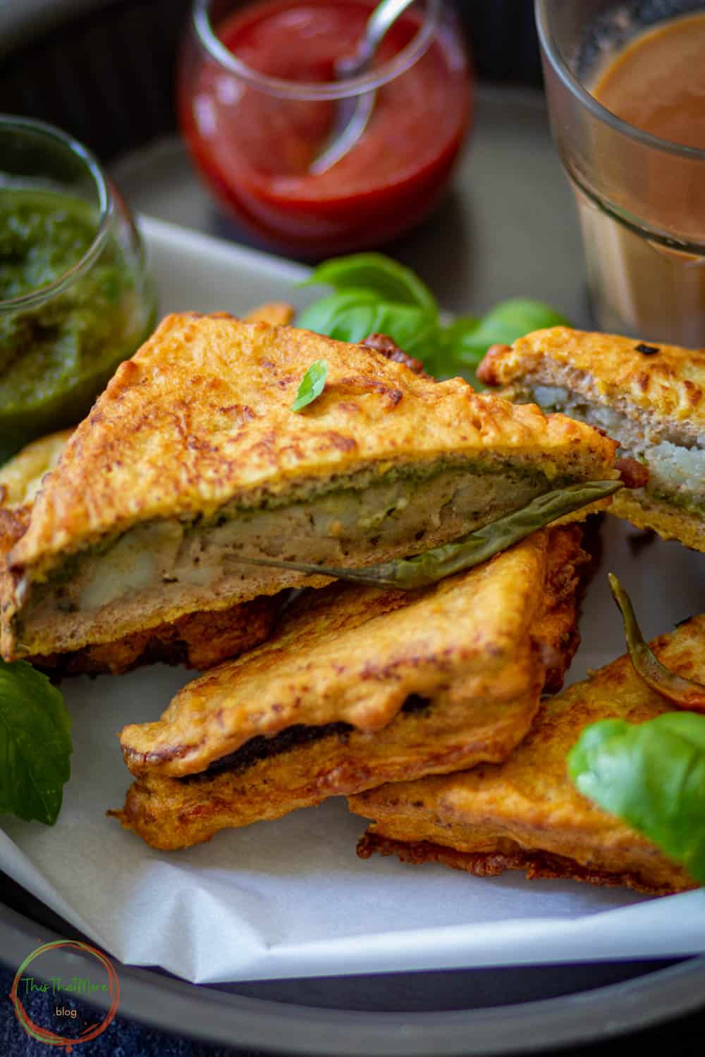 Bread Pakora served on a plate with sauces.