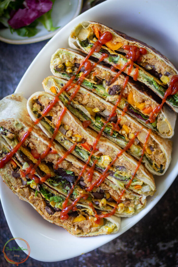 crunchwrap supreme lined in a bowla nd sriracha sauce is drizzled on the top