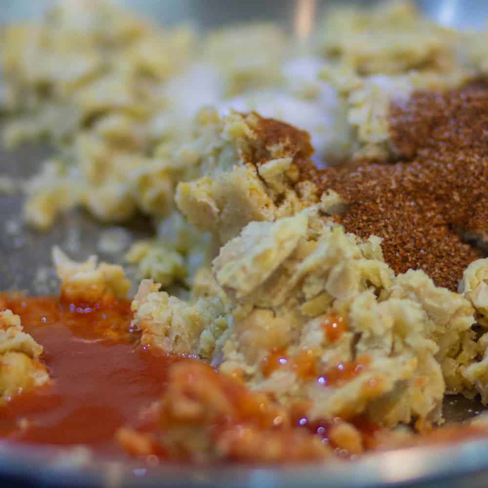 add the taco seasoning, cayenne pepper, and hot sauce in mashed chickpeas