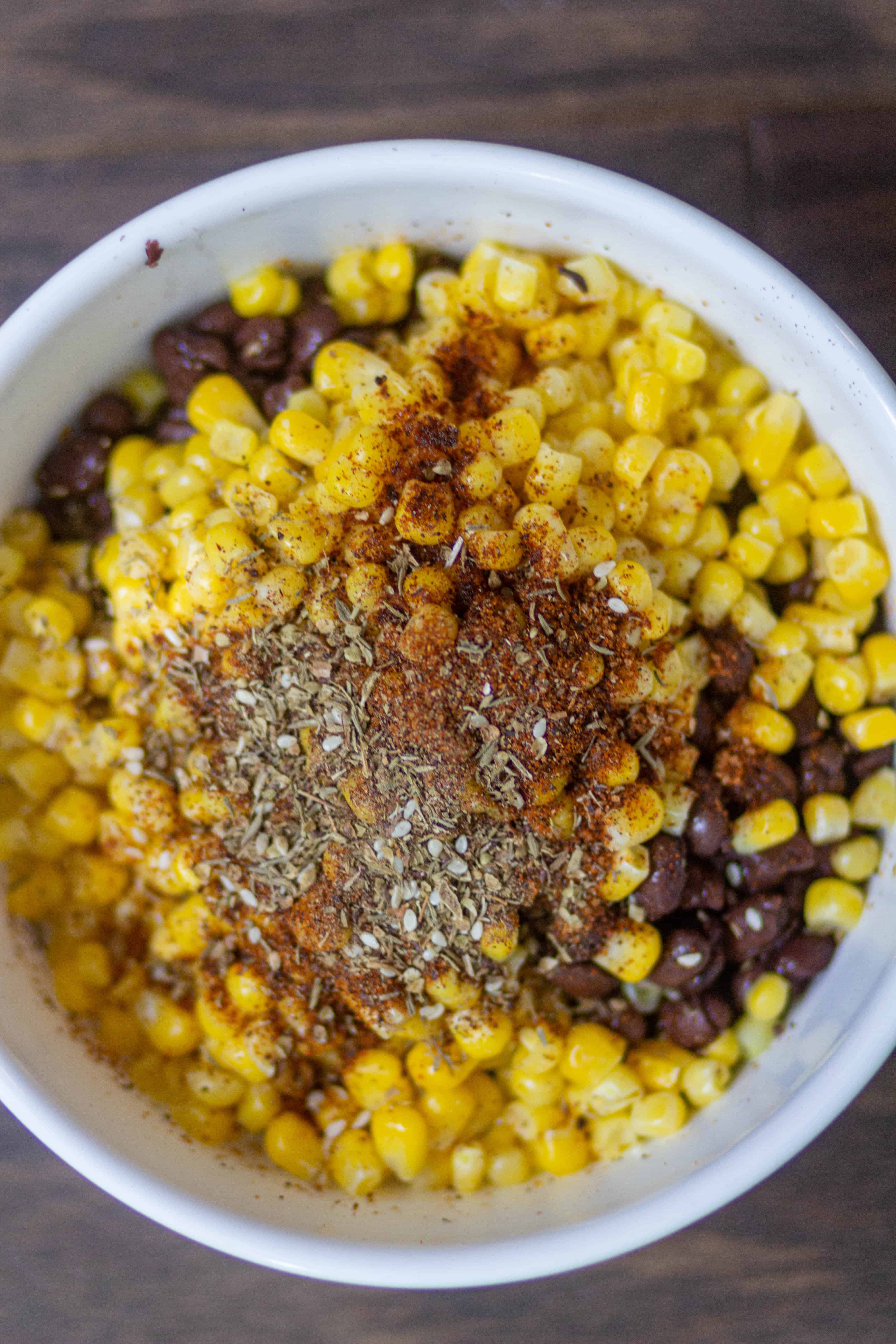 make black bean and corns filling by adding black beans, corns, salt, and taco seasoning in a bowl