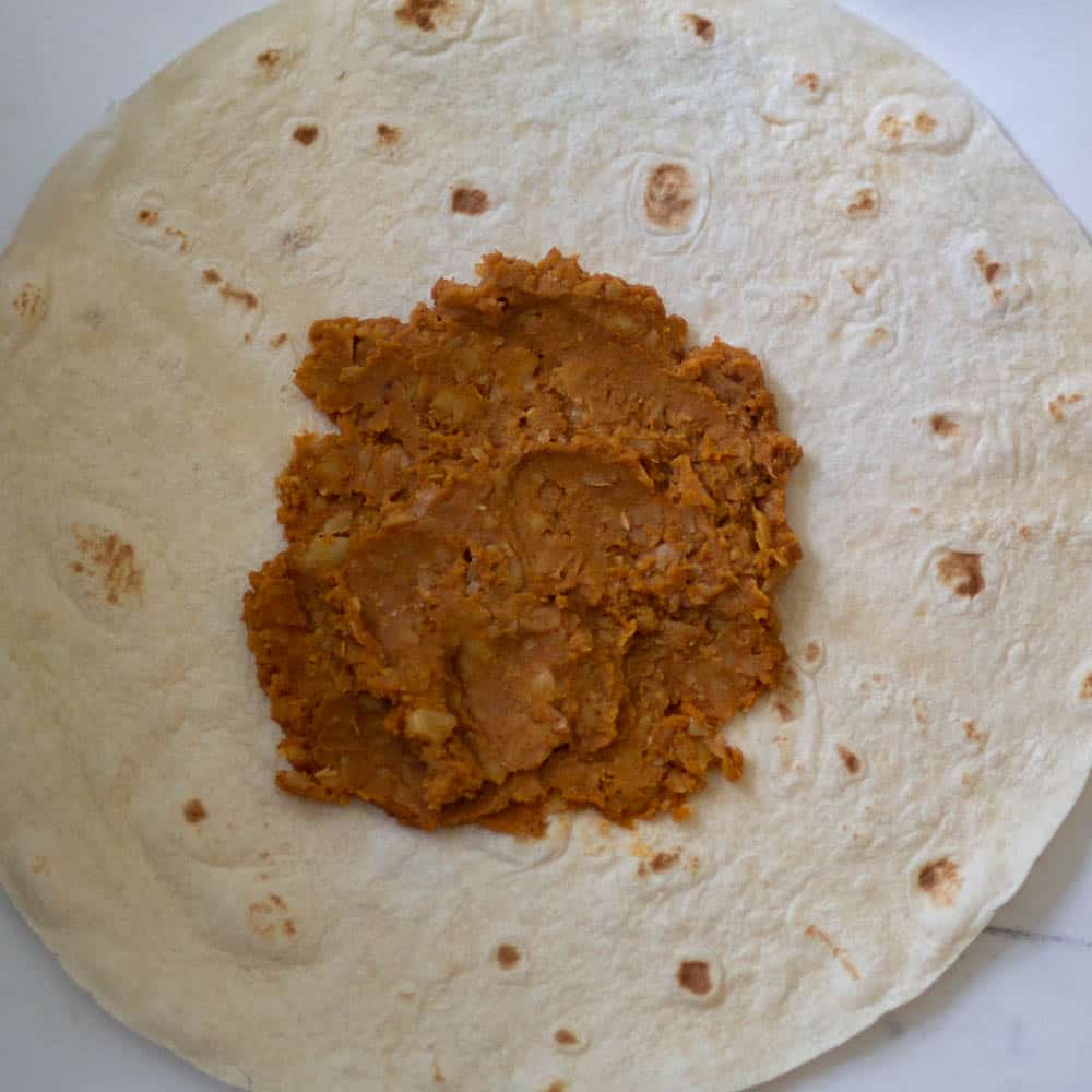 add chickpea filling on the burrito size tortilla