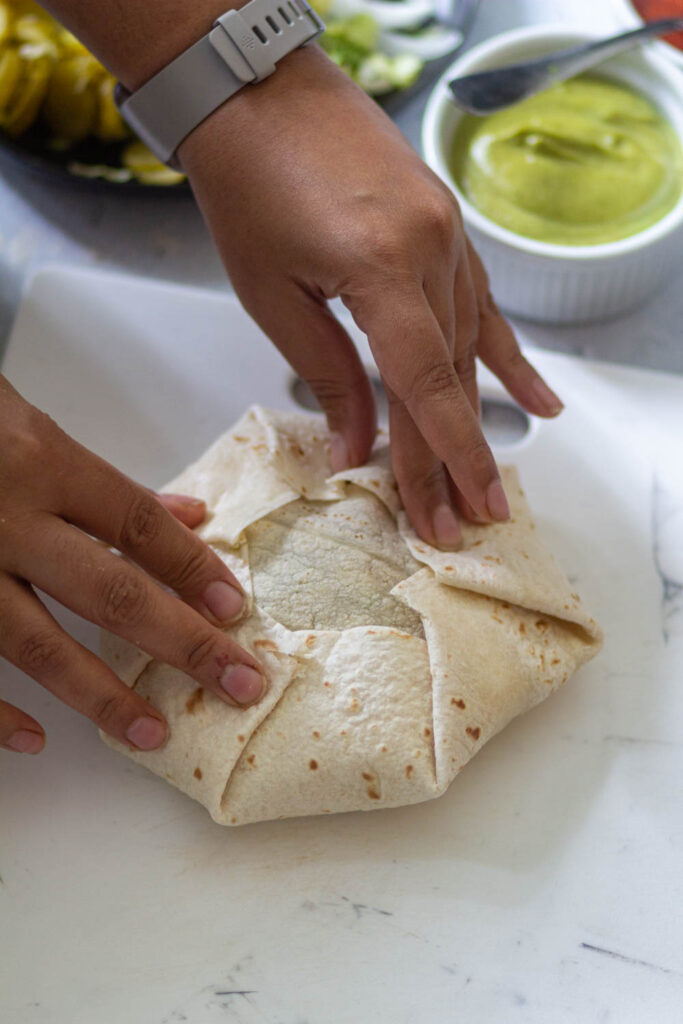 fold the edges until it shape into hexagon-shaped crunchwrap