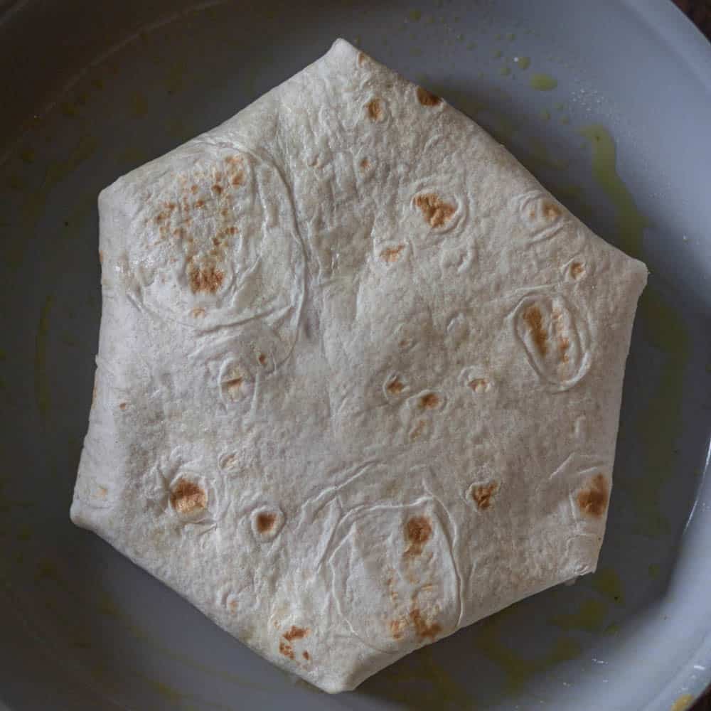 place the tortilla on the skillet over medium-heat