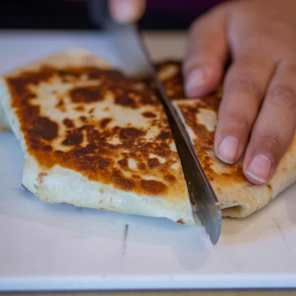 place the cooked ht ecrunchwrap and cut it from the middle