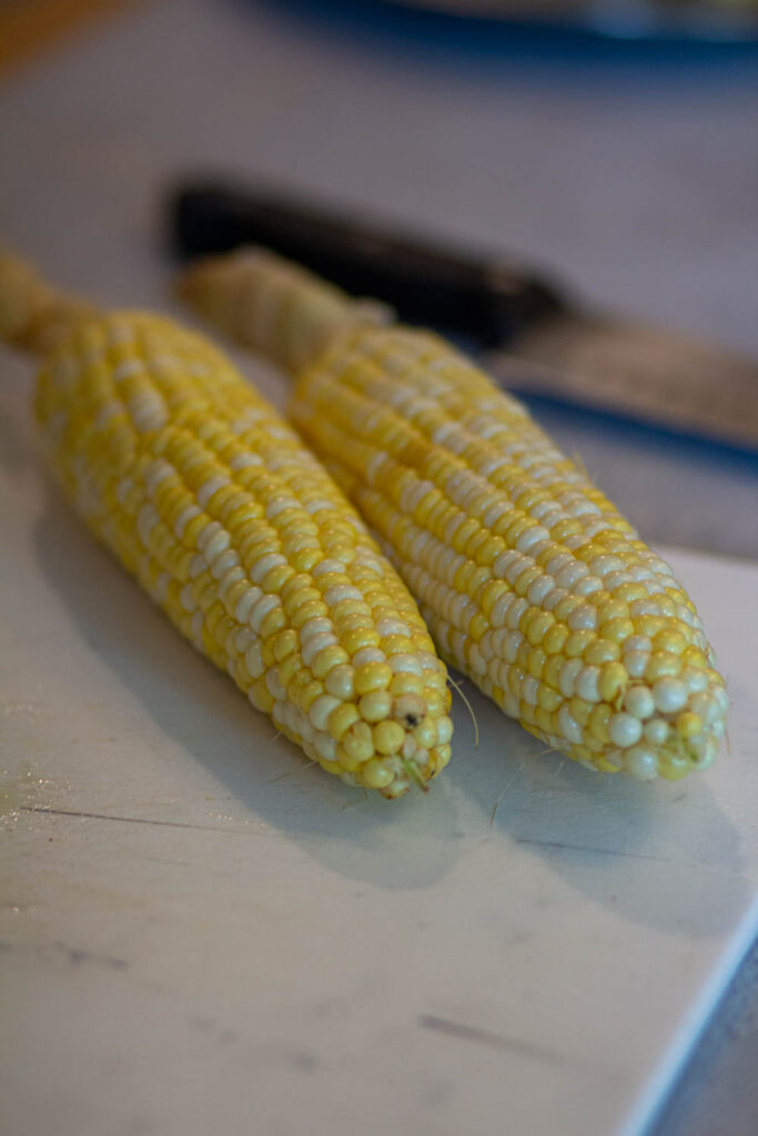 place all the corns on the cutting board