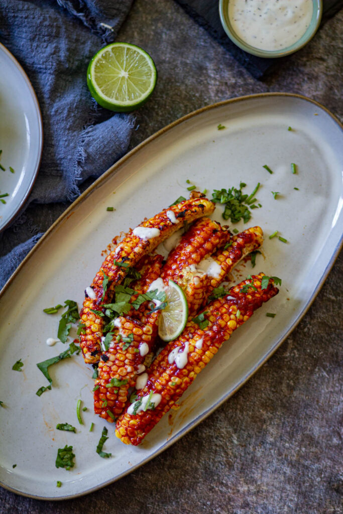 corn ribs on a big white plate, placed diagonally