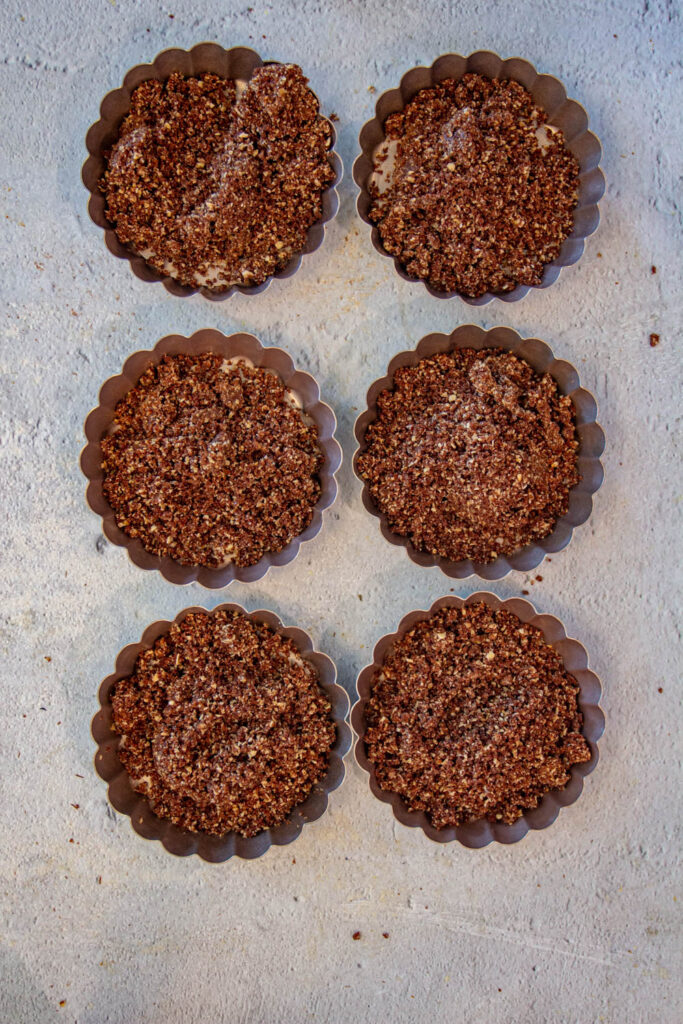 add the crust dough in the tart pans