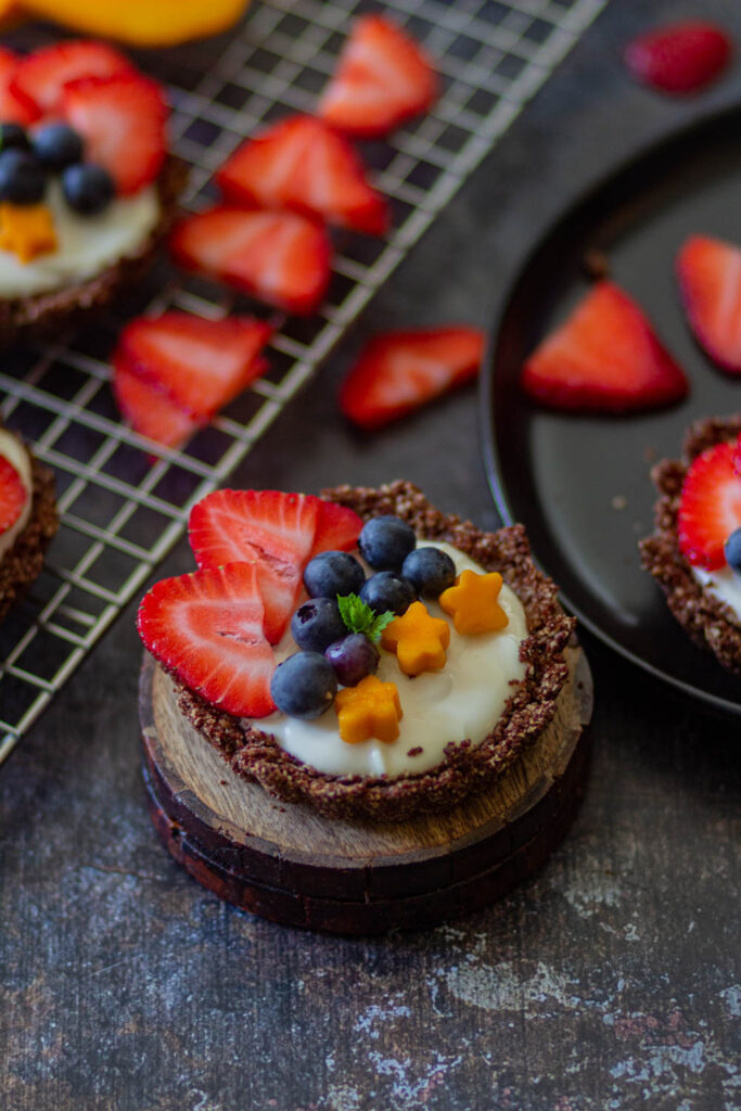 Mini Fruit Tar on small brown coasters