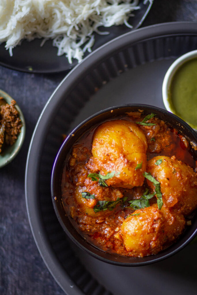 dum aloo in a small bowl placed on a grey plate