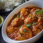 dum aloo recipe in white bowl coated with masala